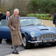 Prince Charles in front of his vintage Aston Martin car